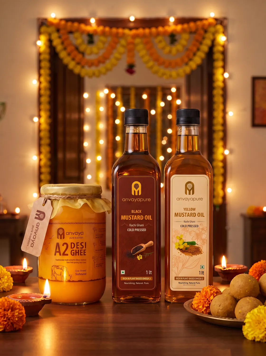 A2 Desi Cow Ghee with our black and yellow mustard oils among lit diyas and marigolds, in front of a doorway hung with a marigold toran